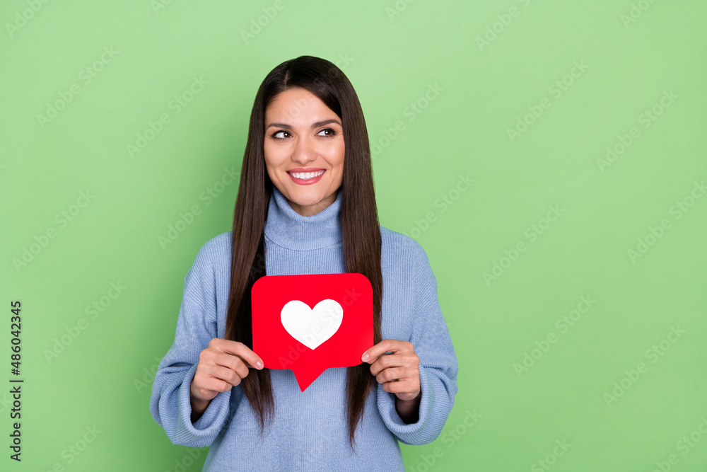 Photo of optimistic millennial brunette lady show like look promo wear blue sweater isolated on green color background Photo of optimistic millennial brunette lady show like look promo wear blue sweater isolated on green color background