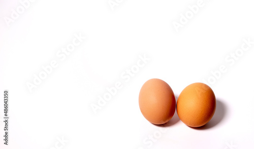 two chicken eggs on the right on a white background