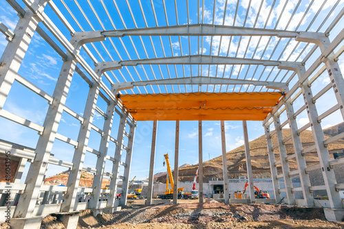 Interior view of the walls, supports, and roof of a precast commercial industrial prefabricated (precast) concrete. It is a construction product produced by casting concrete in a reusable mold.