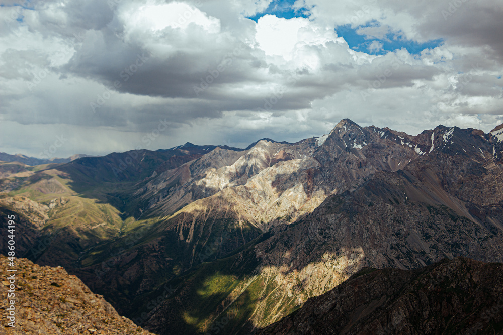 amazing mountain peaks under blue sky and clouds