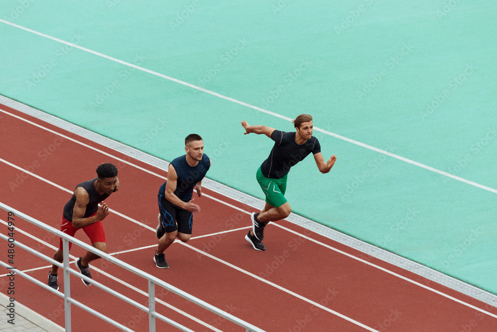 Obraz premium Sports men running on treadmill on stadium