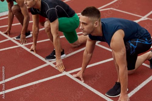 Sportsmen waiting start of run on treadmill