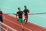 Sportsmen run on finish on treadmill on stadium