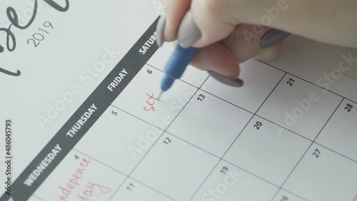 The word sex is written in a red pen in a close-up calendar