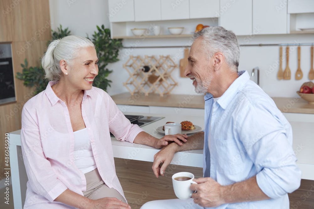 Senior caucasian couple talk during have breakfast