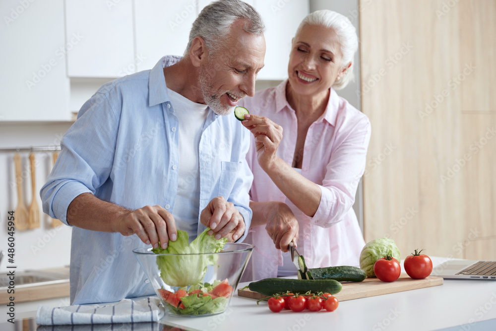 Man throw cabbage in bowl while his wife feed his Man throw cabbage in bowl while his wife feed his