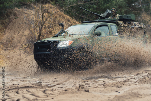  Protected Patrol Vehicle of British armed forces cruising in dirt . High quality photo