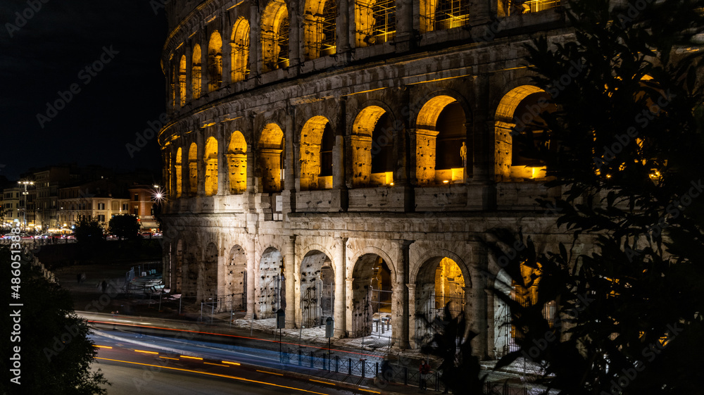 Cars light trails near the Coloseum,    Rome, Italy. Also Known As Flavian Amphitheatre In Evening Or Night Time. Famous World Landmark