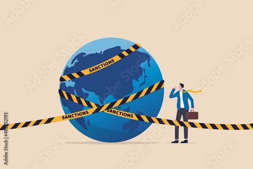World economic sanctions, force country to obey international law by limit or stop trading concept, businessman look at planet earth world country with prohibited yellow tape with word sanctions. photo