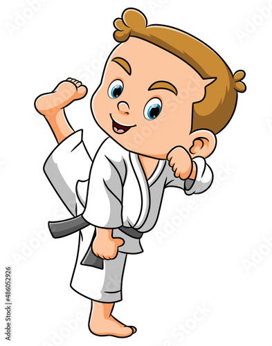 The boy is playing the taekwondo and swinging the foot