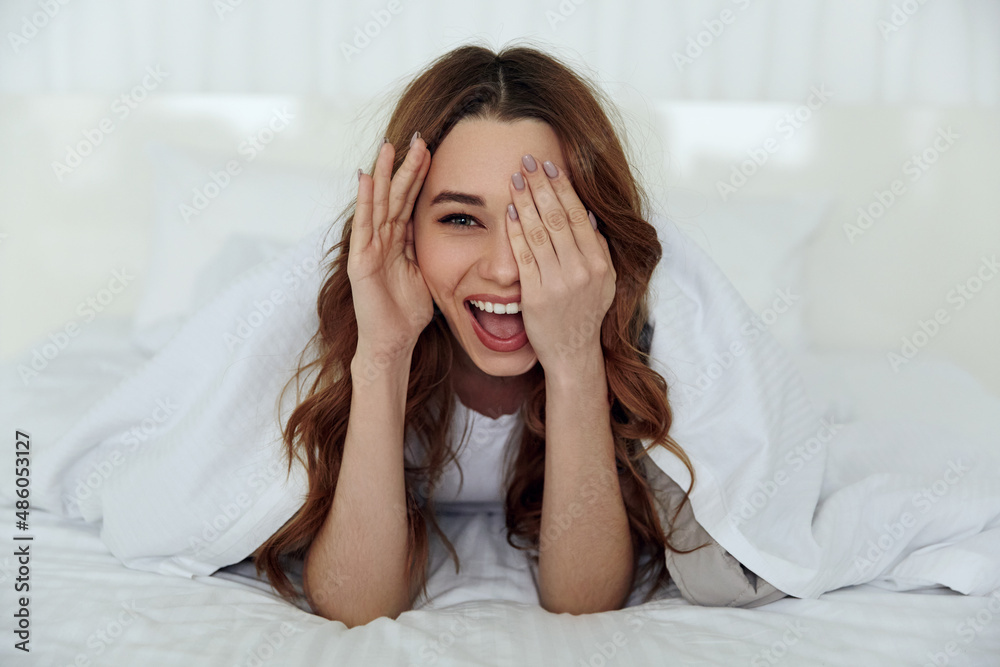 Caucasian girl resting on bed at home at morning