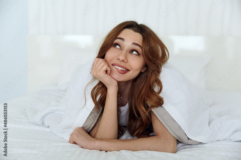 Caucasian girl resting on bed at home at morning Caucasian girl resting on bed at home at morning