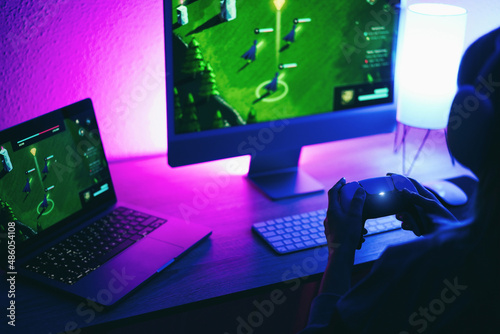 Gamer playing strategy game online using wireless controller - Focus on right hand