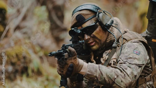 British Army Ranger on the war zone peace mission aiming an automatic rifle with scope. High quality 4k footage