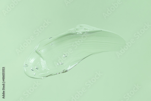 Smear of transparent cosmetic gel on mint background.Copy space for text,mockup concept.