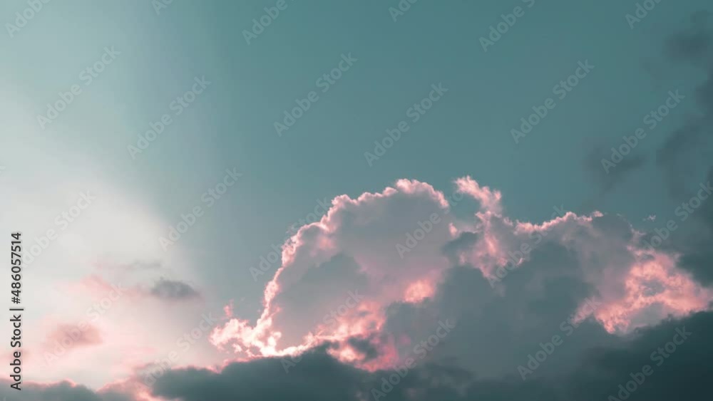 Pastel pink clouds n sun light ray or sunbeam in blue sky TimeLapse