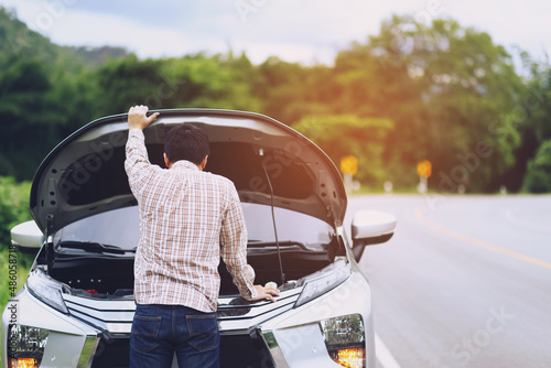 young stressed man having trouble with his Stress broken car  Engine room crash at failed engine Wait for help.