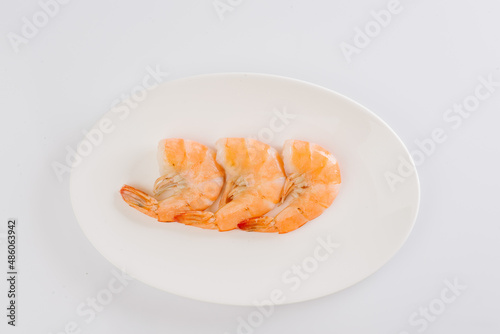 boiled king prawns on a white plate on a white background