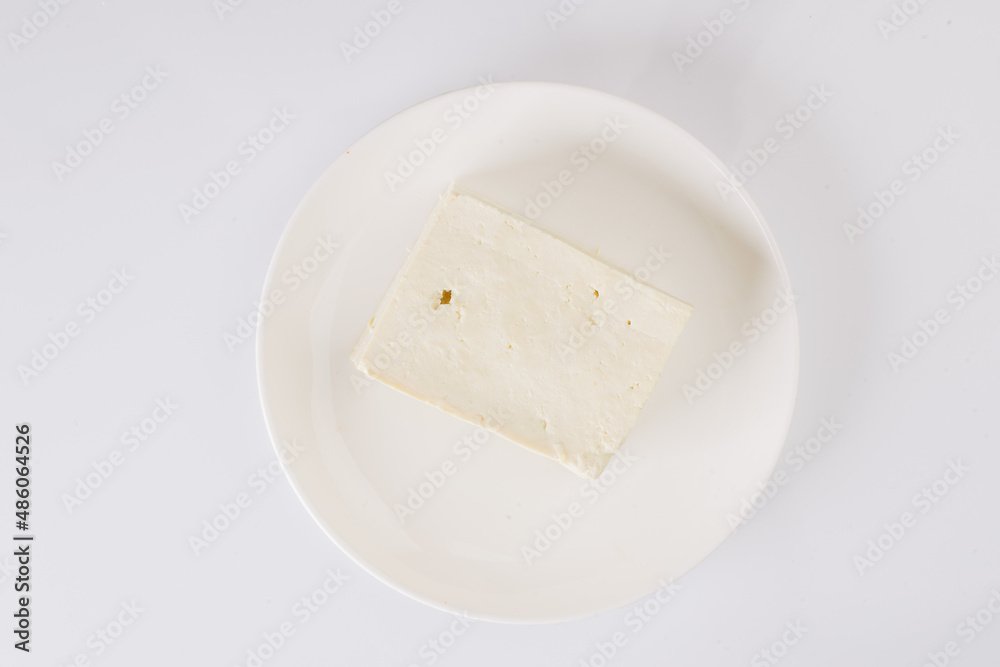 tofu cheese on a white plate on a white background