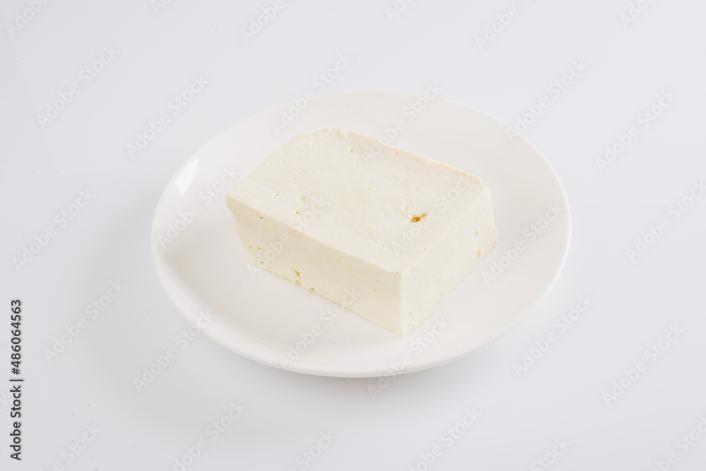 tofu cheese on a white plate on a white background
