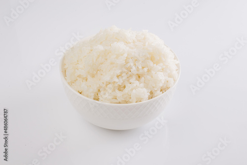boiled rice on a white plate on a white background