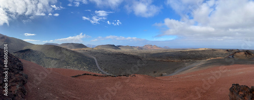 Volcanic landscape with cloudy sky and bricky color ground