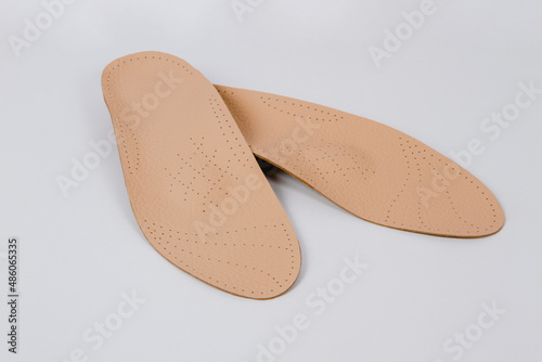 Isolated orthopedic insoles on a white background. Medical insoles. Foot care. Insole cutaway layers. Treatment and prevention of flat feet and foot diseases. Inner soles of shoes.