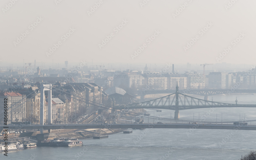 Hazy cityscape of Budapest with bridges over Danube river in Hungary