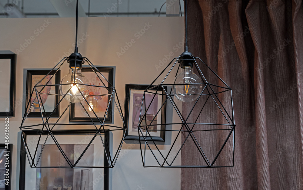 Black metal lamps with filament light lamps in loft style.