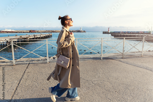 Φωτογραφία Young adult trendy stylish beautiful caucasian happy smiling woman enjoy walking by Yalta sea embankment on warm sunny day