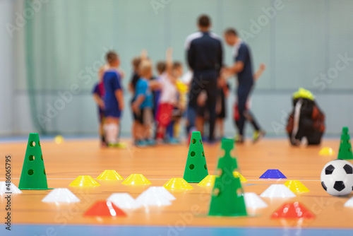 Futsal Soccer Training Court. Kids in a Group With Coaches in Blurred Background. Kids on Physical Education Class at School photo