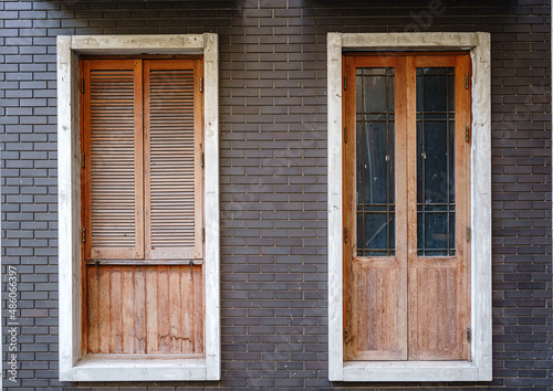 Wooden door and windows on brick wall.