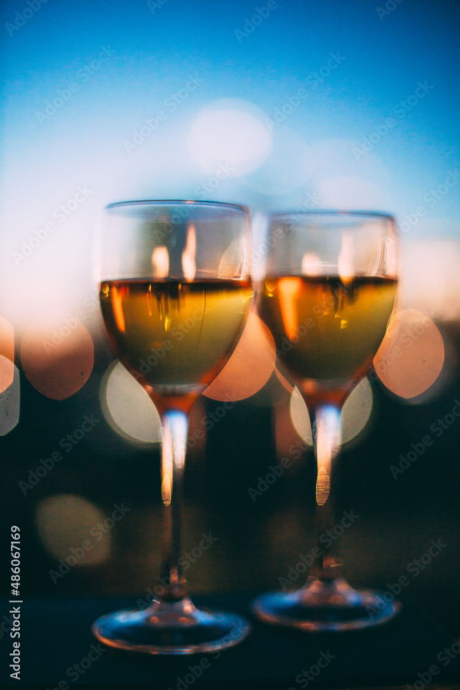 champagne glasses are on the windowsill against the sunset champagne glasses are on the windowsill against the sunset