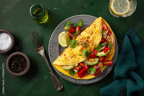 Obraz na płótnie omelette with tomato, avocado onion chili and sweet corn. healthy keto diet low carb breakfast w salonie