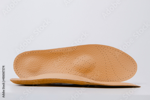 Isolated orthopedic insoles on a white background. Medical insoles. Foot care. Insole cutaway layers. Treatment and prevention of flat feet and foot diseases. Inner soles of shoes.