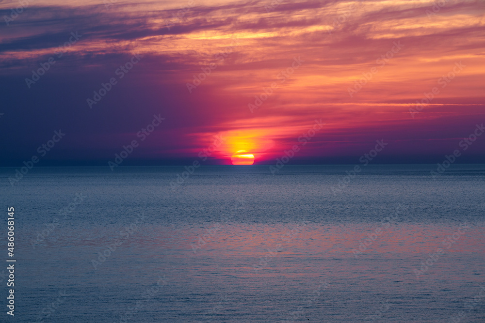 Obraz premium Sunrise at the sea. Beautiful summer view seascape. Amazing sunrise. Morning landscape. Waves with foam. Romantic relax places.