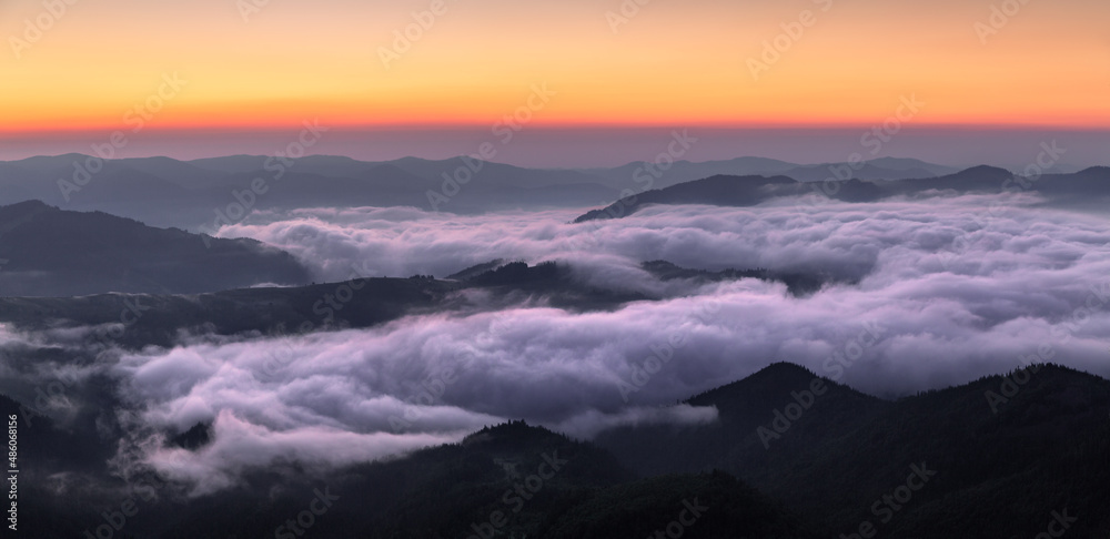 Landscape with high mountains. Panorama with amazing sunrise. Fields and meadow are covered with morning fog and dew. Touristic resort Carpathian national park, Ukraine Europe. Natural scenery.
