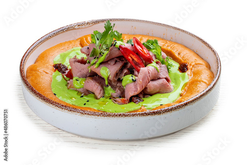Hummus with veal sous-vide and parsley cream.