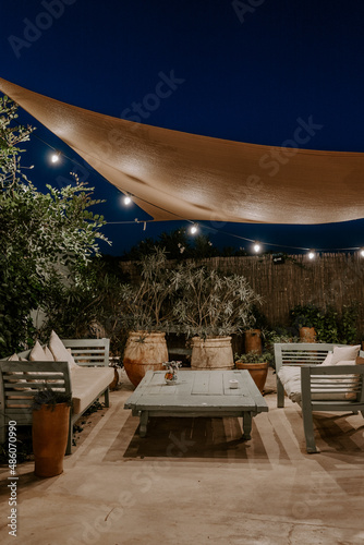 Canvastavla Cozy outdoor dining setup in Greece, illuminated by warm ambient lighting