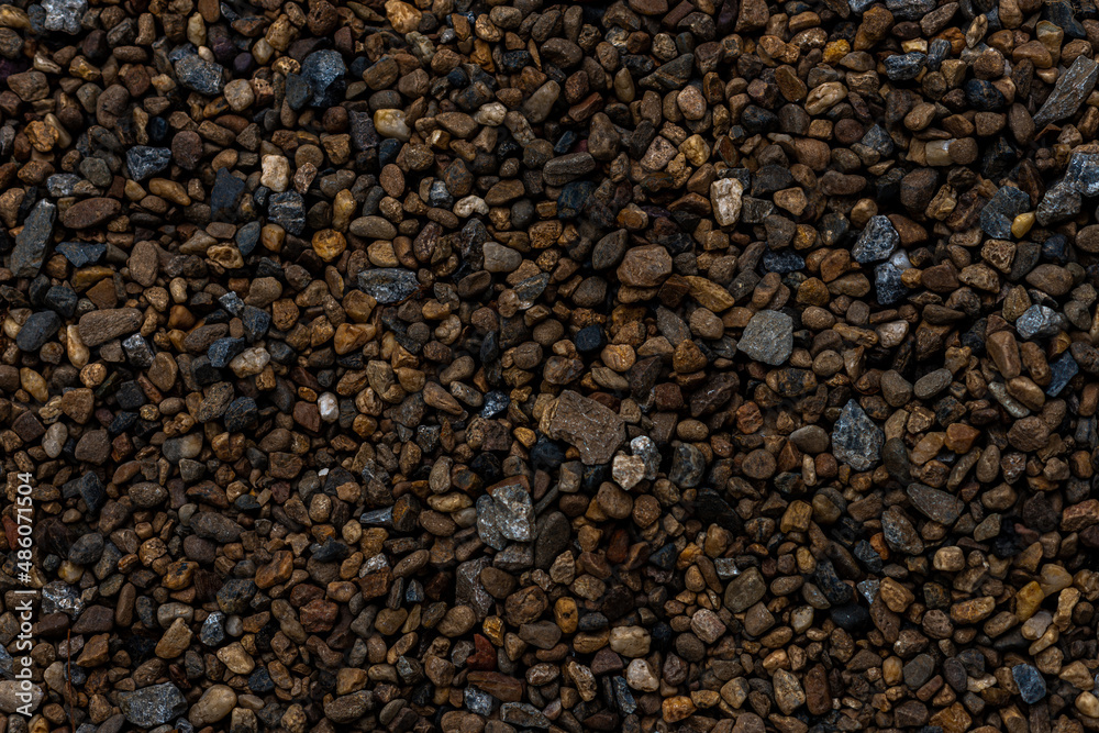 Natural smooth dark pebbles stone grain texture and Grunge, pebble floor image. Blank wallpaper abstract stone backdrop for background or product design graphic artwork and interior design Natural smooth dark pebbles stone grain texture and Grunge, pebble floor image. Blank wallpaper abstract stone backdrop for background or product design graphic artwork and interior design