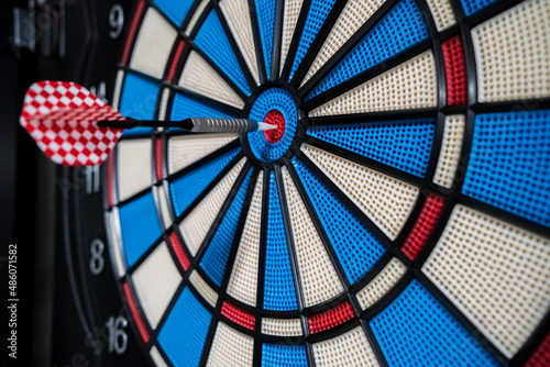 Single red dart on dartboard bullseye. Victory concept