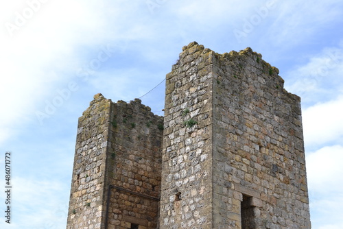 castle tower in Siena, Italy, with old brown bricks and blue sky in the background, in beautiful day