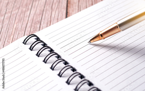 ball pen on a white page of a notebook for investment planning 