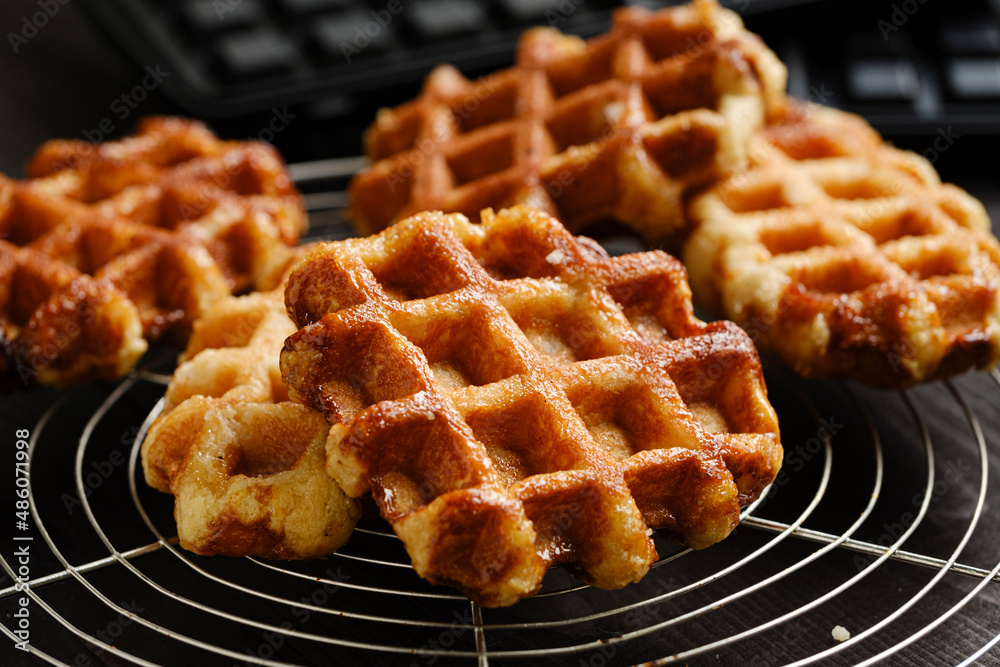 Homemade Belgian Waffles from the city of Liege on round steel trivet Homemade Belgian Waffles from the city of Liege on round steel trivet