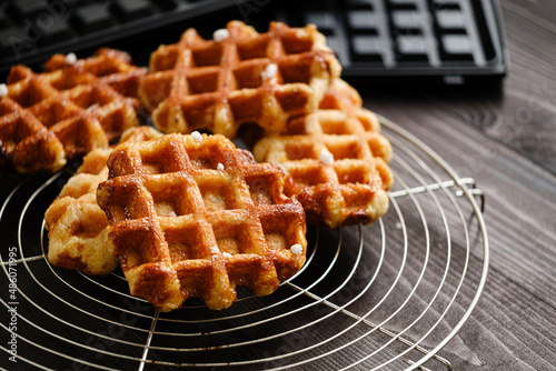 Homemade Belgian Waffles from the city of Liege on round steel trivet photo