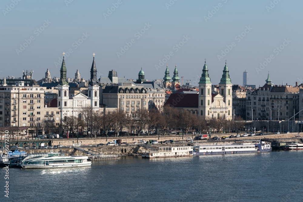 Cityscape with orthodox and catholic church on Danube riverbank in Budapest, Hungary
