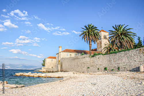 Beautiful resort along Dalmatian Coast,Trogir, Croatia. Sunny promenade along the pier of old Venetian town, Dalmatian Coast in Croatia.