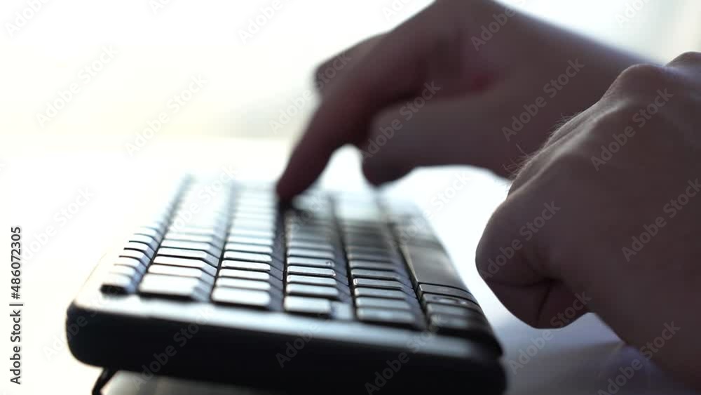 A Man Starts Typing on a Computer Keyboard. Close-up. Side View. Slow Motion A Man Starts Typing on a Computer Keyboard. Close-up. Side View. Slow Motion