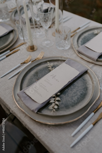 Elegant destination wedding table setting featuring a neutral color palette fine tableware floral arrangements and personalized menus. A perfect image for luxury events, receptions, and celebrations
