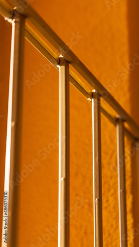 Old metal fence. Morning sunlight in the entrance of a residential building